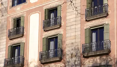 a facade of a building with windows and balconies at Duquesa Suites Landmark Hotel by Grup Duquessa in Barcelona