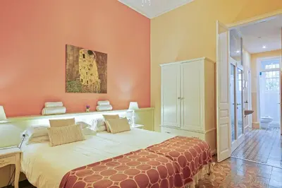 a bedroom with a bed and a painting on the wall at Villa Modernista in Barcelona