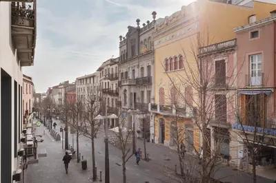 a city street with buildings and people walking down the street at Matarolux 5 in Mataró