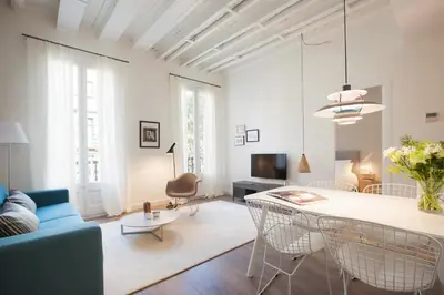 a living room with a blue couch and a table at En Casa de Girona 17 in Barcelona