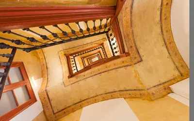 an overhead view of a spiral staircase with a window at En Casa de Girona 17 in Barcelona