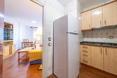 a living room with a couch and a table at HomeHolidaysRentals Sol in Pineda de Mar