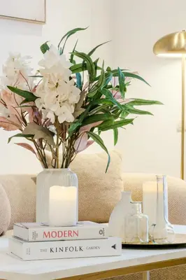 a framed mirror sitting on a shelf next to a statue at Four Petals Barcelona Boutique Apartments in Barcelona