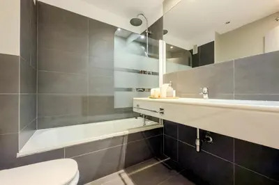 a bathroom with a toilet and a sink and a tub at Four Petals Barcelona Boutique Apartments in Barcelona