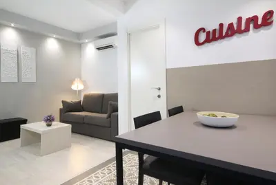 a living room with a table and a couch at Suite Place Barcelona Còrsega in Barcelona
