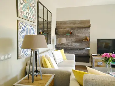 a living room with a couch and a table with a lamp at Ferran Pedralbes Penthouse in Barcelona