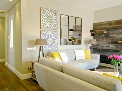 a living room with a couch and a fireplace at Ferran Pedralbes Penthouse in Barcelona