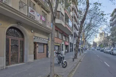 a motorcycle parked on the side of a city street at Apartment Lucia in Barcelona