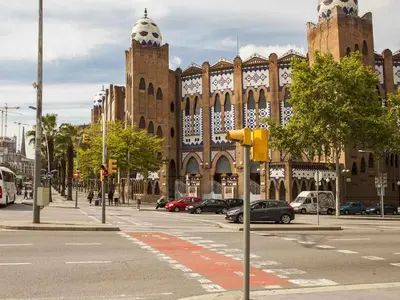 a large building with cars parked on a city street at Apartment Lucia in Barcelona