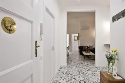 a hallway with a white door and a living room at Apartment in downtown Barcelona - Vintage in Barcelona