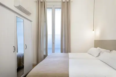 a bedroom with a large bed with a large window at Apartment in downtown Barcelona - Vintage in Barcelona