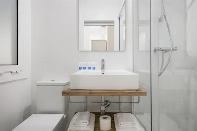a white bathroom with a sink and a shower at Apartment in downtown Barcelona - Vintage in Barcelona