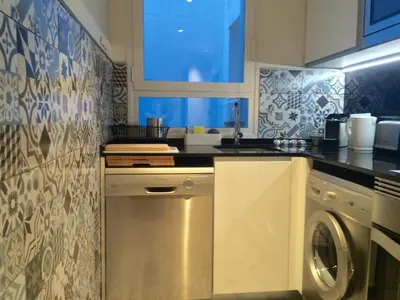 a kitchen with a sink and a washing machine at Passeig de Gracia Apartment in Barcelona