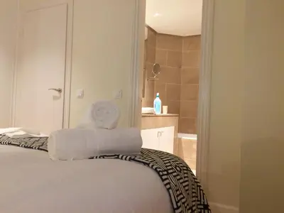 a bedroom with a bed with towels on it at Passeig de Gracia Apartment in Barcelona