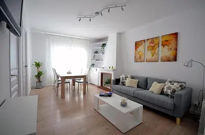 a living room with a couch and a table at Sunny Apartment Central Sitges in Sitges