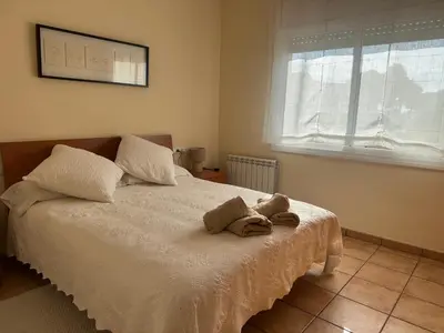 a bedroom with a bed with two towels on it at Apartaments Villa Conchi in Sitges