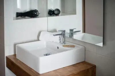 a bathroom with a white sink and a mirror at Apartments Mo in Monistrol