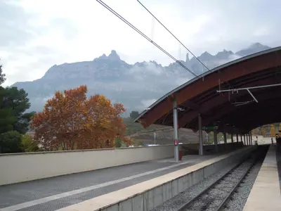 a train station with the mountains in the background at Apartments Mo in Monistrol