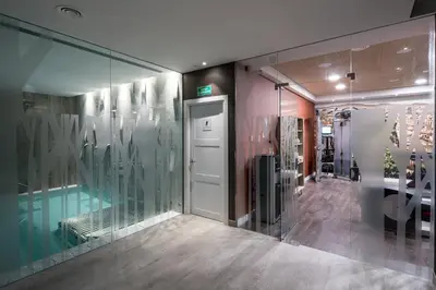 a room with a swimming pool and a glass wall at Catalonia Magdalenes in Barcelona