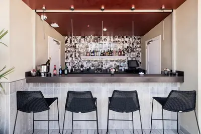 a bar with four chairs and a counter at Catalonia Magdalenes in Barcelona