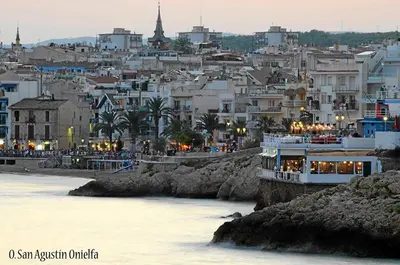 a view of a city with a boat in the water at Apartment Aloha Sitges in Sitges