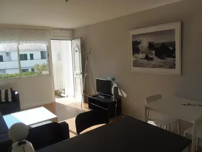 a living room with a couch and a table and a television at Apartment Aloha Sitges in Sitges