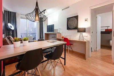 a living room with a dining room table and chairs at Habitat Apartments Hot Jazz in Barcelona