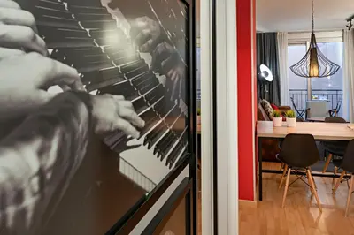 a person is putting something in an oven at Habitat Apartments Hot Jazz in Barcelona