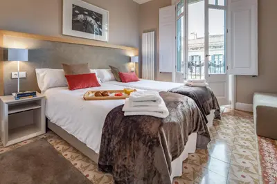 a bedroom with two beds with towels on them at Habitat Apartments Barcelona Classic in Barcelona