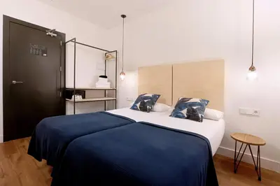 a bedroom with a large bed with a blue blanket at Magatzem 128 in Barcelona