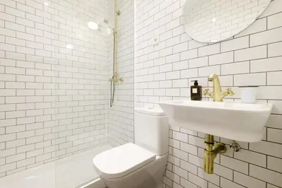 a white bathroom with a sink and a toilet at Magatzem 128 in Barcelona