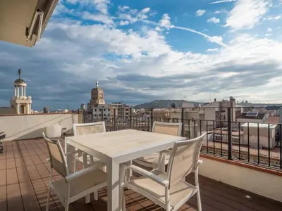 a living room with a couch and a large window at Rent Top Apartments Rambla Catalunya in Barcelona