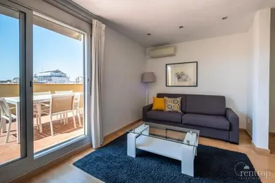 a living room with a table and a chair at Rent Top Apartments Rambla Catalunya in Barcelona