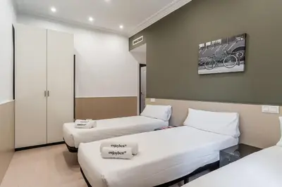 a hospital room with two beds and a painting on the wall at Enjoybcn Tapies Apartment in Barcelona