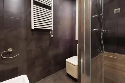 a bathroom with a toilet and a sink and a shower at Enjoybcn Tapies Apartment in Barcelona