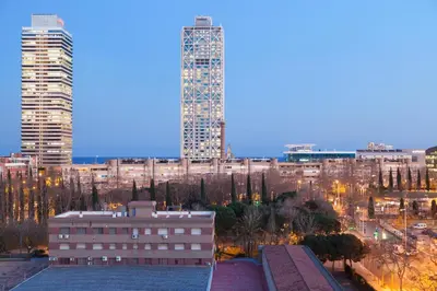 a view of a city skyline with a tall building at Enjoybcn Marina Apartment in Barcelona