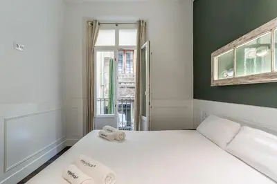 a bedroom with a bed with two towels on it at Enjoybcn Tallers Apartment in Barcelona