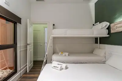 a small room with two bunk beds in it at Enjoybcn Tallers Apartment in Barcelona