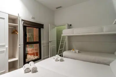 a bedroom with two bunk beds and a ladder at Enjoybcn Tallers Apartment in Barcelona