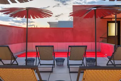a group of chairs and umbrellas on a patio at Hotel La Pau in Barcelona