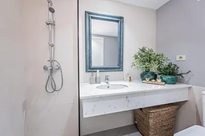 a white bathroom with a sink and a mirror at Sweett - Villa Olimpica Mediterranean in Barcelona