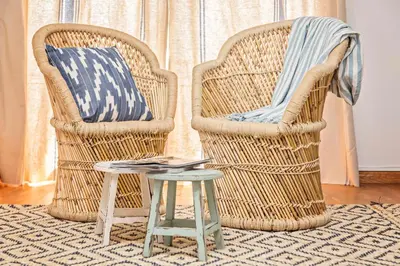 two wicker chairs and a table in a living room at Sweett - Villa Olimpica Mediterranean in Barcelona