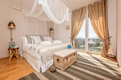 a bedroom with a large bed and a large window at Sweett - Villa Olimpica Mediterranean in Barcelona