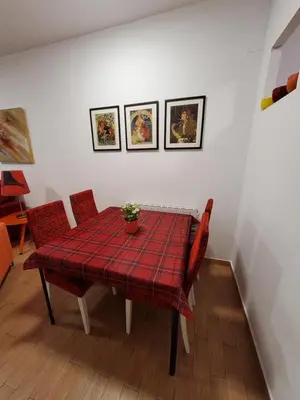 a dining room table with a red plaid table cloth at Apartment Sant Sebastià in Sitges