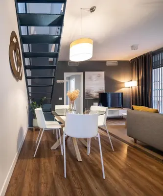 a dining room with a table and chairs at Feelathome Poblenou Beach Apartments in Barcelona