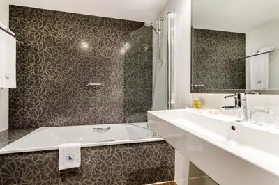 a white bathroom with a sink and a shower at Eurostars Executive in Barbera del Valles