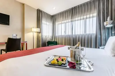 a tray of food on a bed in a hotel room at Eurostars Executive in Barbera del Valles