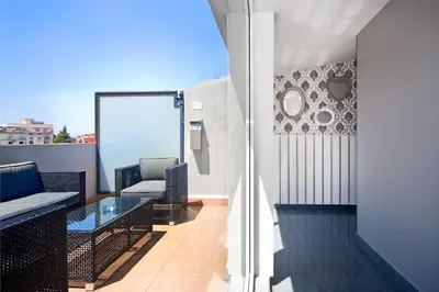 a balcony with a couch and a glass table at HOTEL SANT PERE ll HSPII in Rubí