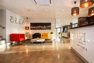 a lobby with chairs and a table in a building at HOTEL SANT PERE ll HSPII in Rubí