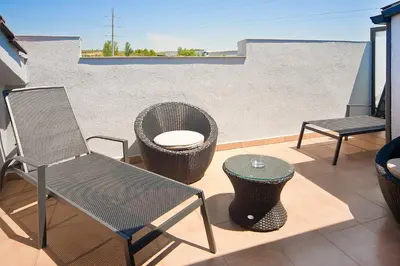 a patio with two chairs and a table and a tableearcher at HOTEL SANT PERE ll HSPII in Rubí